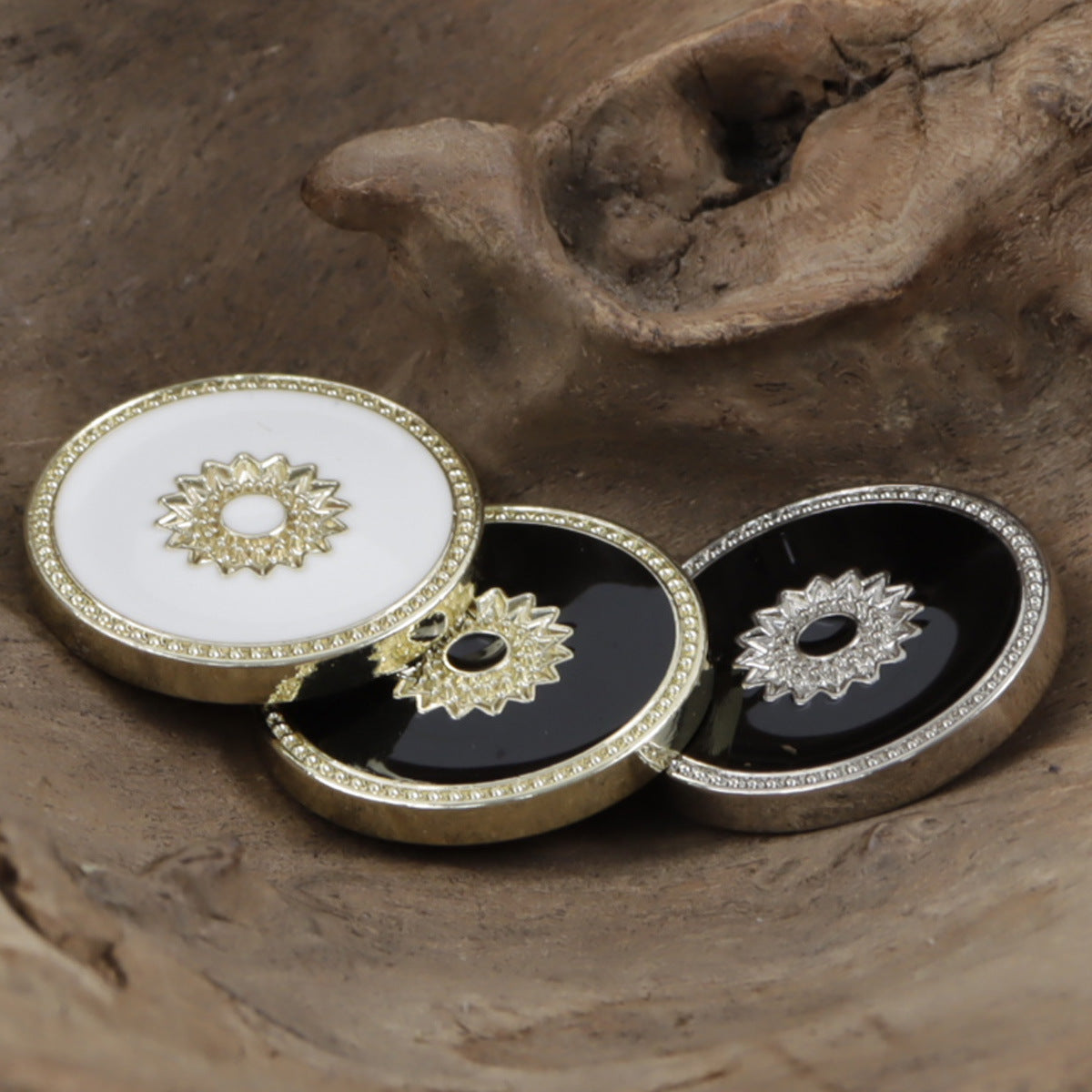 Floral snap buttons with white and black centers, gold-tone and silver-tone rims