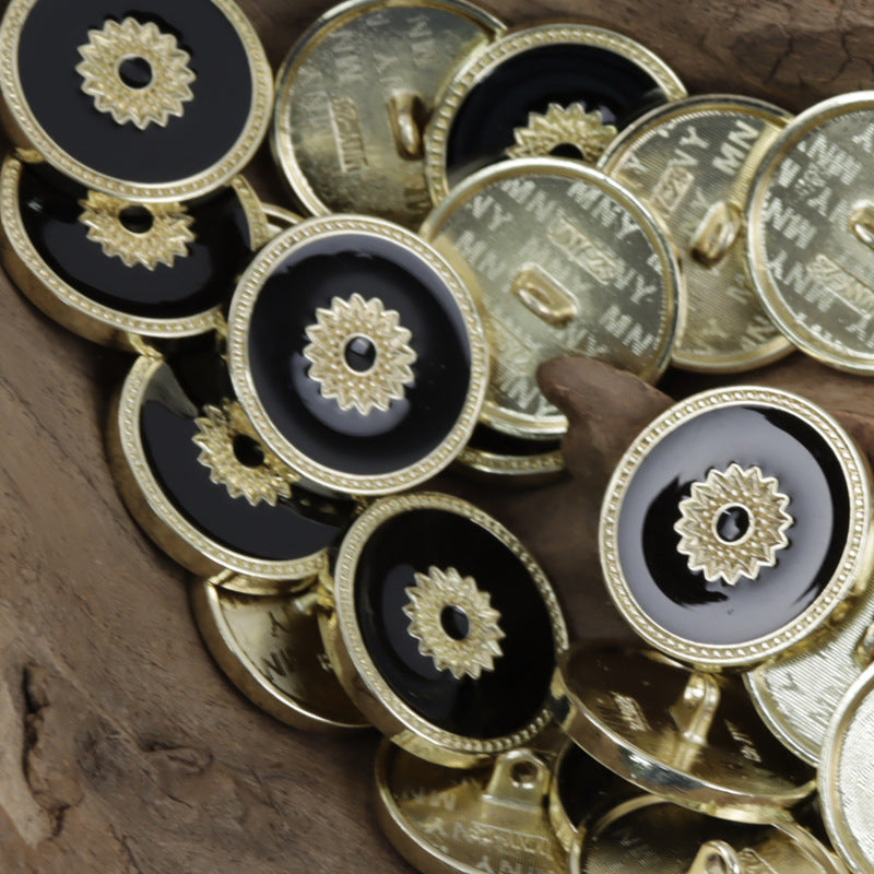 Gold tone floral snap buttons with black centers, ornate star-flower face and rim