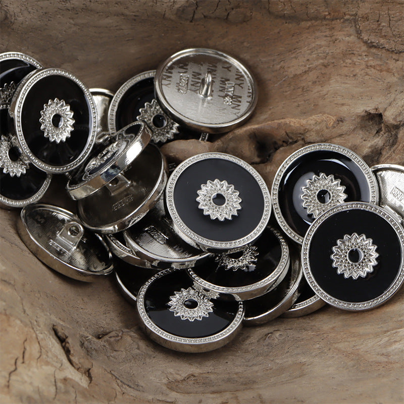 Silver-toned floral snap buttons, black centers with star-flower design and decorative rim