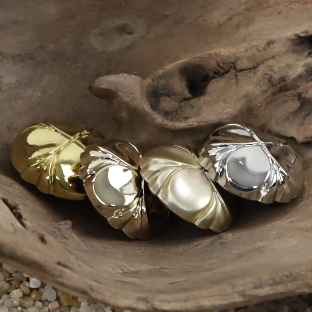 Four-leaf clover metal shank buttons, light gold and silver, close-up detail of shanks