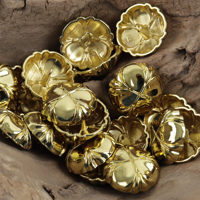 Four-leaf clover metal shank buttons in gold and light gold finishes, multiple buttons