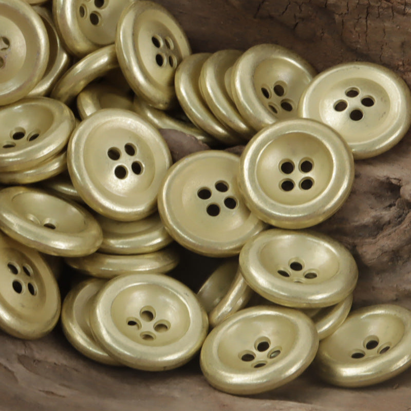 Vintage light gold 4-hole double-sided metal buttons, multiple buttons close-up