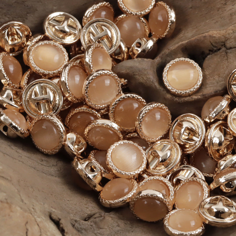 Assorted pearlescent metal buttons with beige front stones, silver-tone scalloped settings