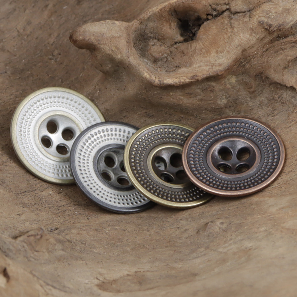 Cap-shaped antique metal buttons with embossed dot ring and 4-hole center
