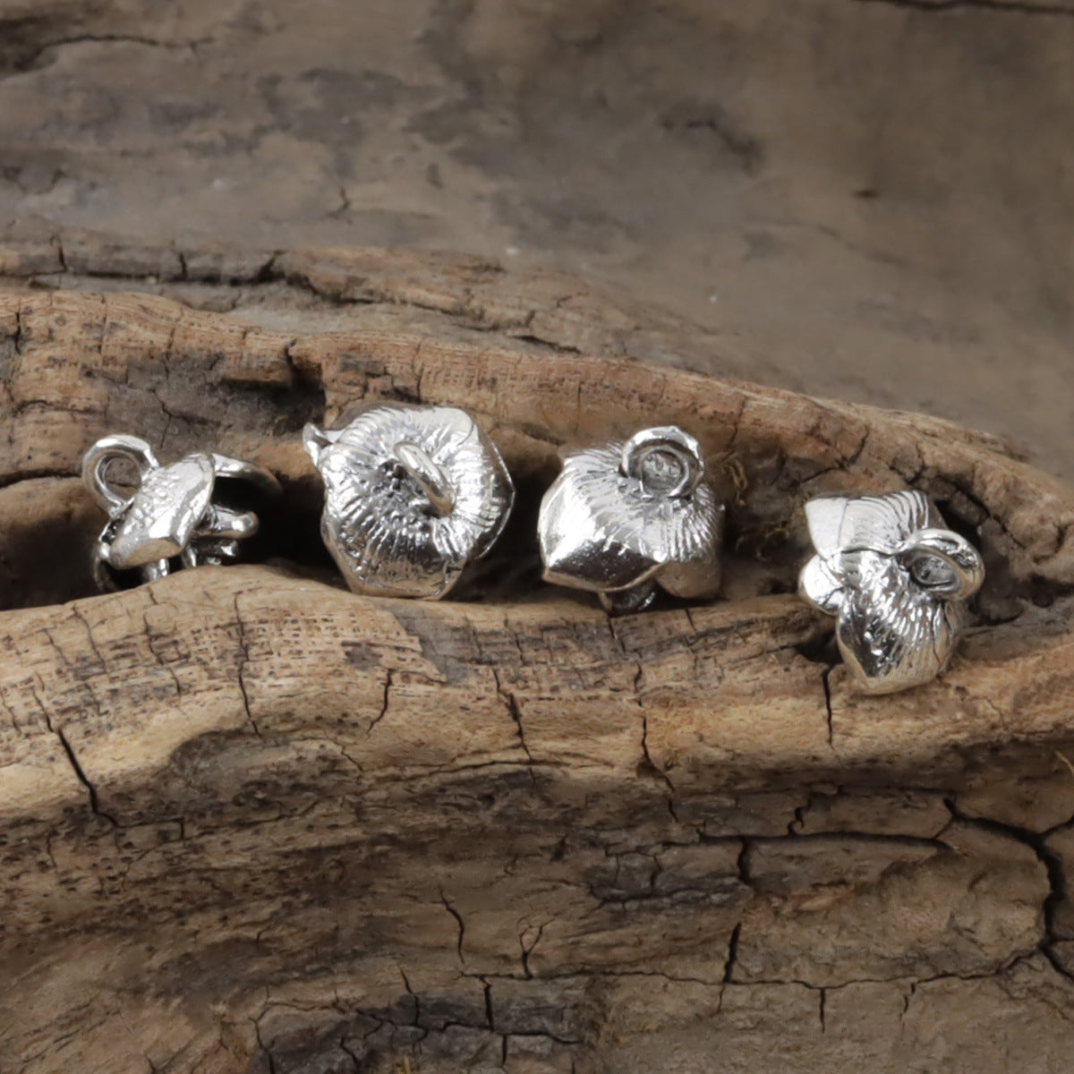 Mini silver metal shank buttons with rose tops, 10mm; four visible
