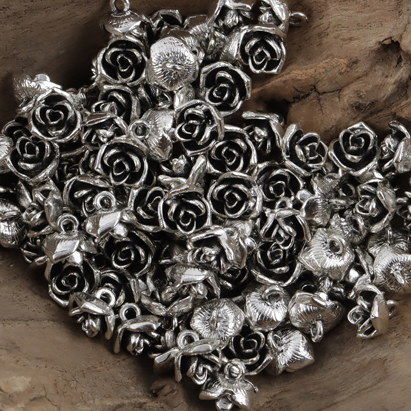 Bulk view of vintage silver 10mm mini rose metal shank buttons, many pieces
