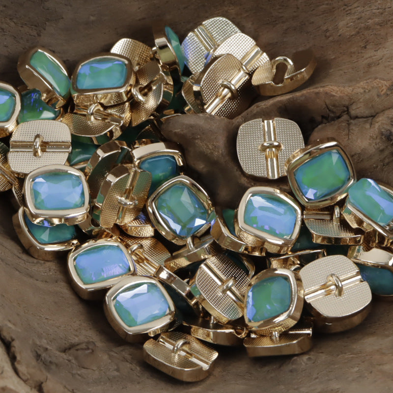 Rhinestone metal shank buttons with teal-blue square stones and gold-tone backs