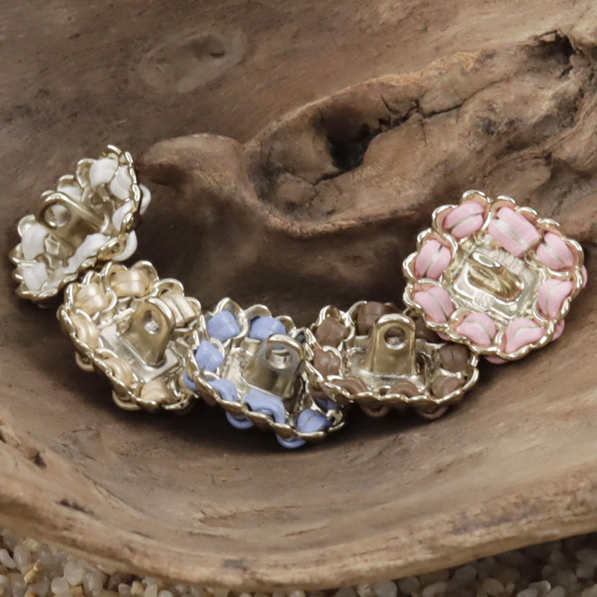 Square pearl buttons on leather cord: pink and blue with gold-toned frames