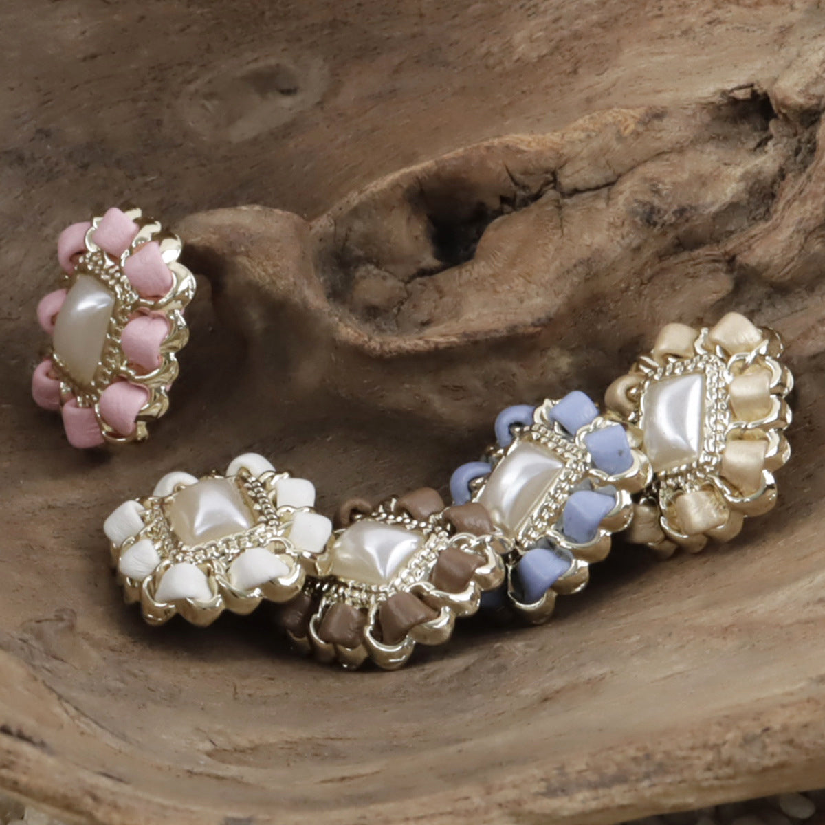 Square pearl buttons on leather cord: pink, blue, and beige squares