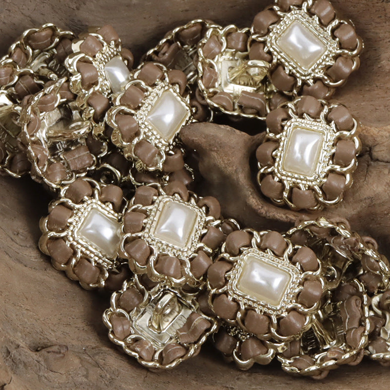 Brown square metal pearl buttons with leather cord weaving, clustered close-up