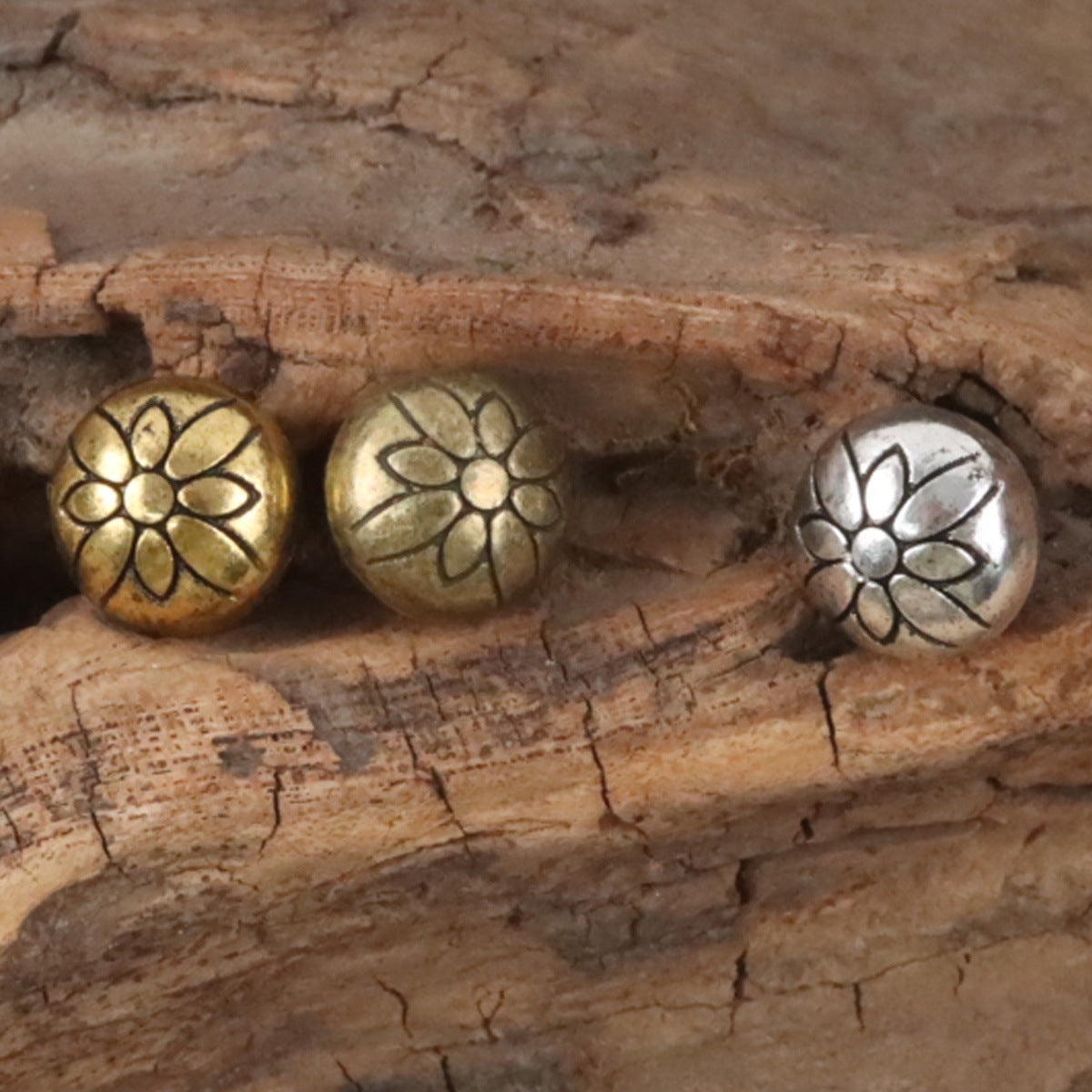 Metal shank buttons: two gold and one silver round floral medallion, loop shanks