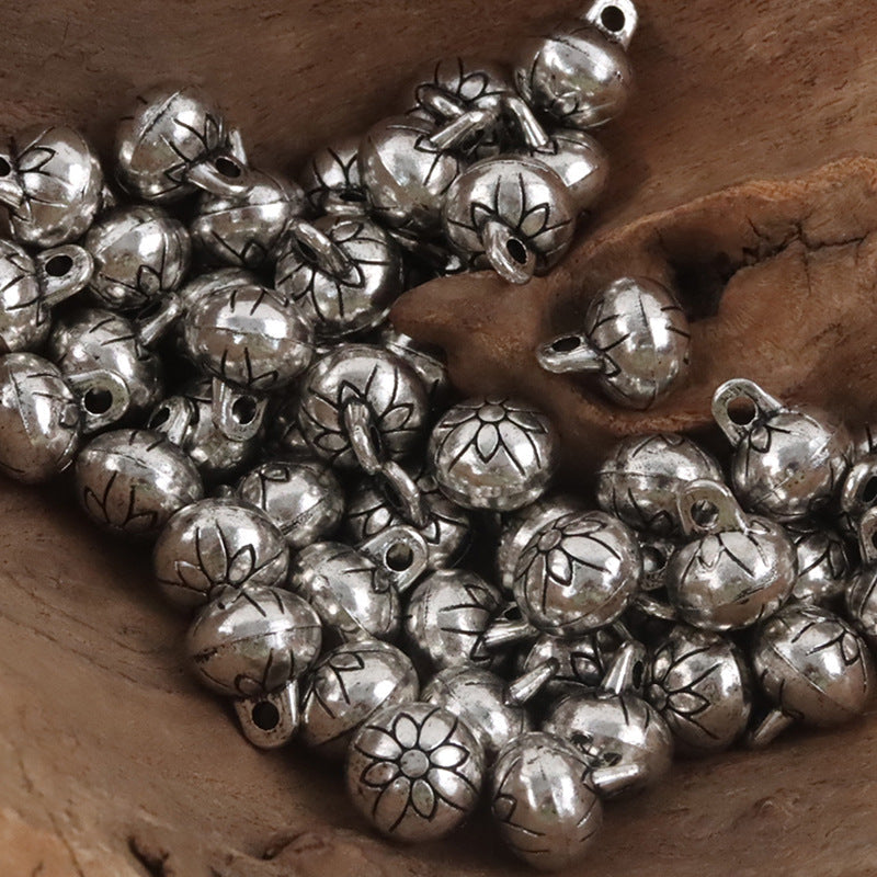Silver round metal shank buttons with floral and knot patterns, loop holes visible