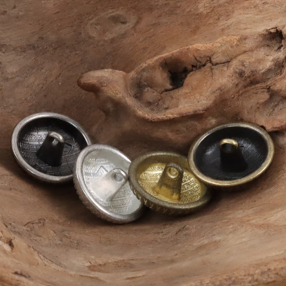 Round shank metal buttons with geometric pattern, mixed silver, bronze, and gold backs