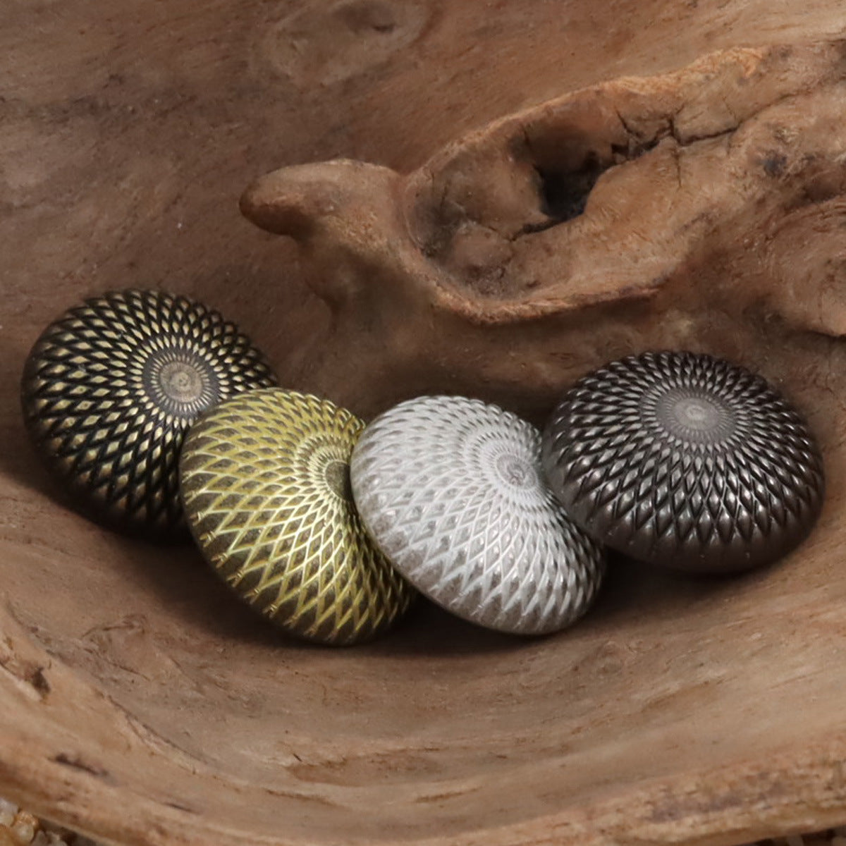 Geometric round shank buttons in black, gold, silver, and dark bronze finishes