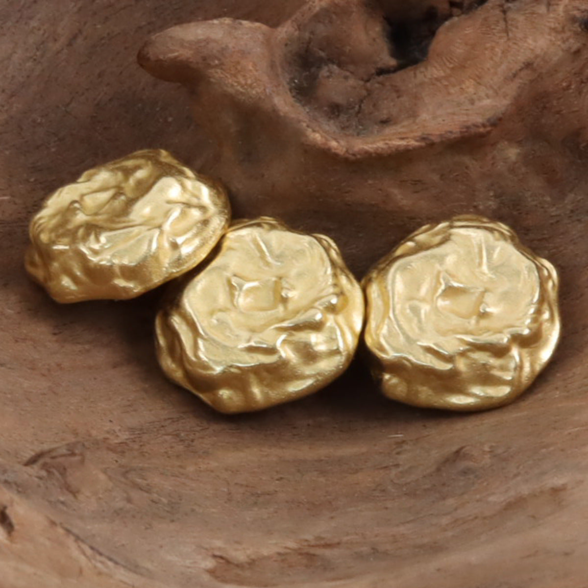 Egyptian-style gold rock metal buttons, angled view of embossed front faces