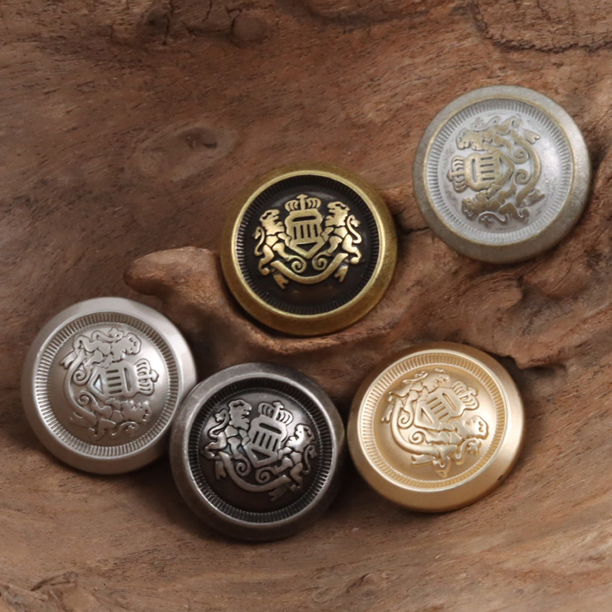 Metal shank buttons with Double Lion Crown crest, black ring, gold and silver tones