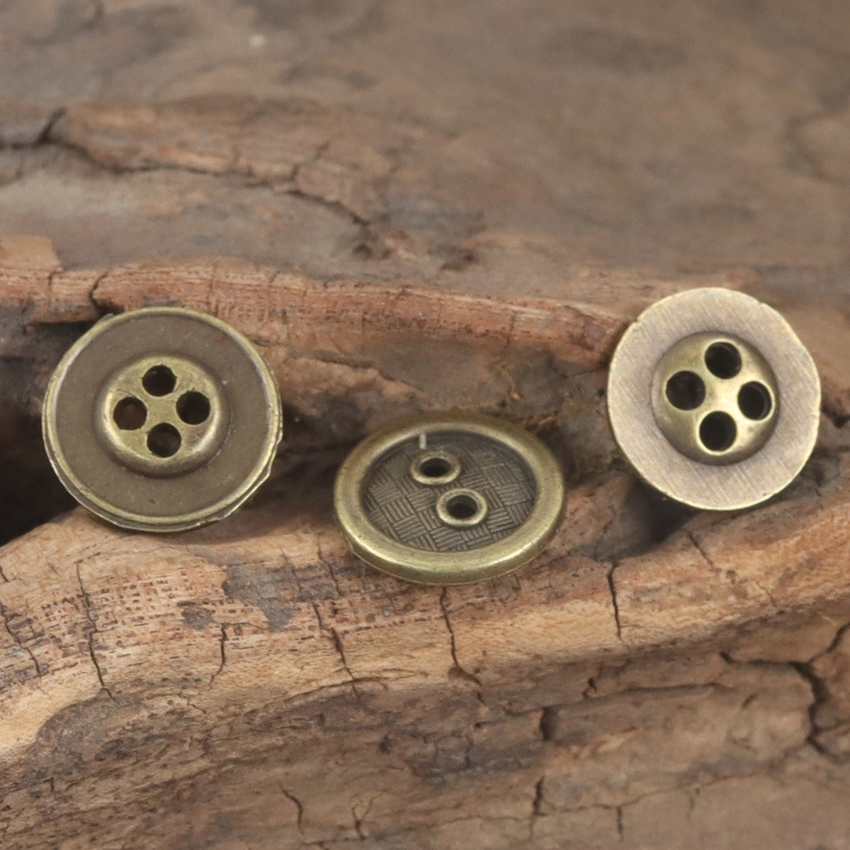 Bronze metal button backs with two to four stitch holes