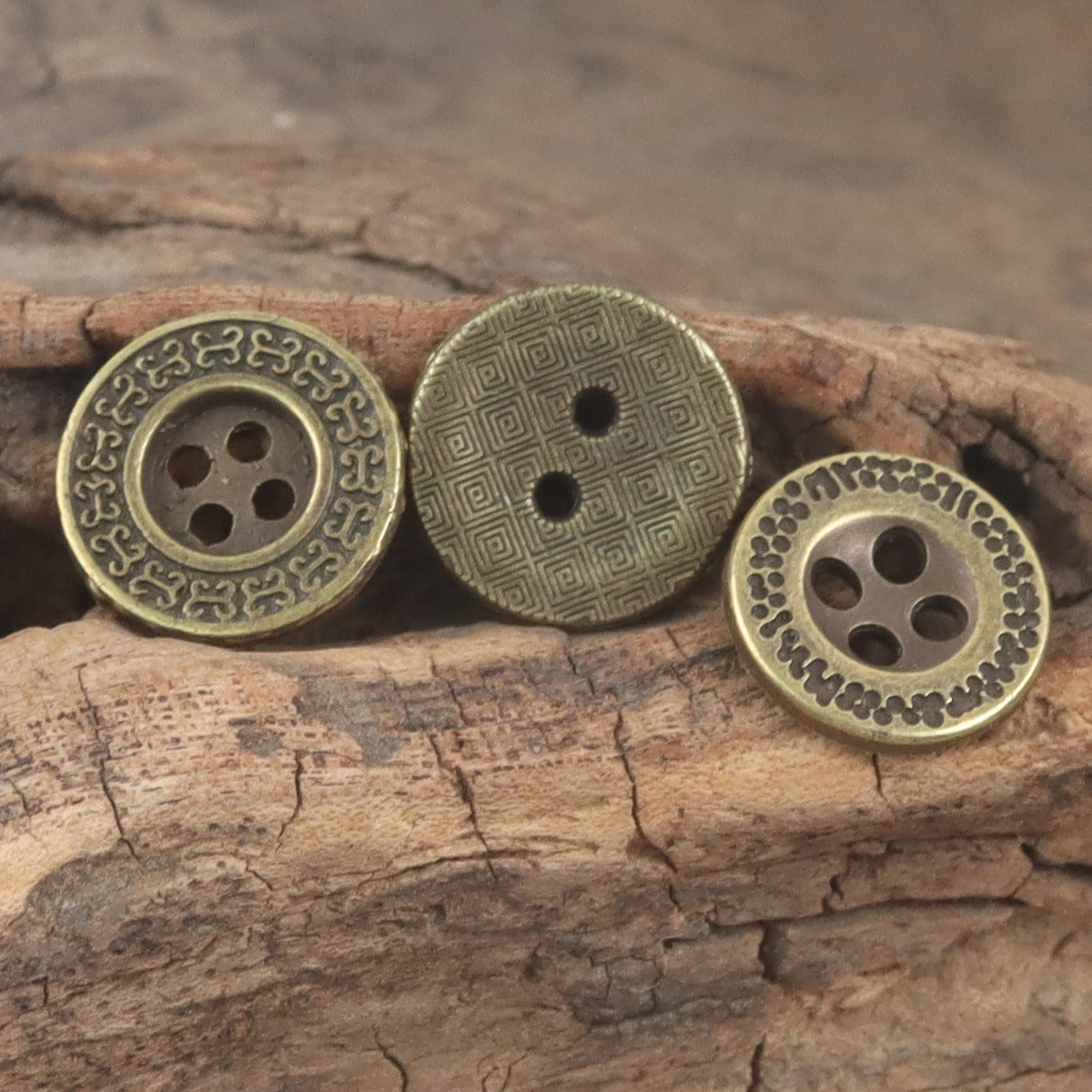 Bronze flat buttons with patterned faces: maze, ornate border, and dotted edge