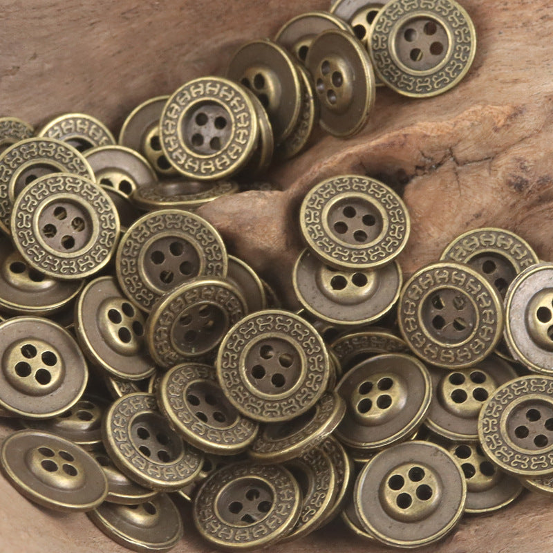 Bronze metal flat buttons pile with maze, ornate, and simple face designs