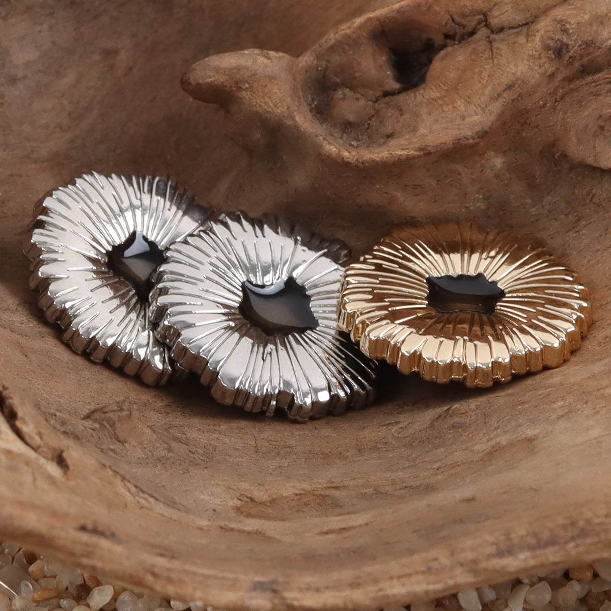 Snowflake metal buttons, black center, silver and gold options on display