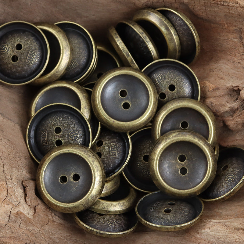 Antique bronze and dark-toned metal buttons, round faces with two holes, distressed