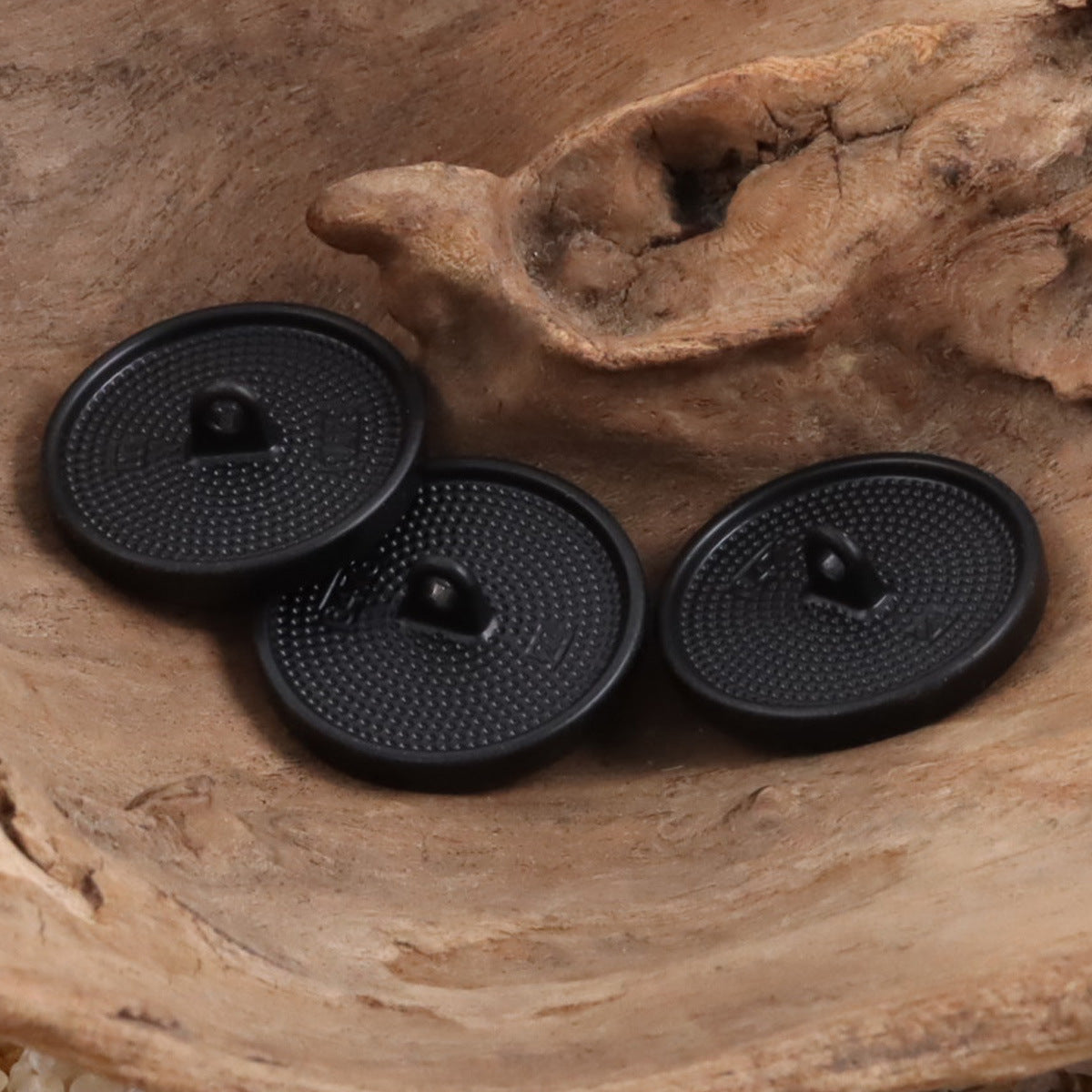 Set of black textured shank buttons with metal thread shank backs, 3 pcs