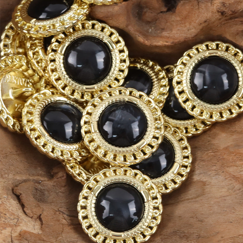Gold-edged buttons with black resin gem centers, shiny round settings