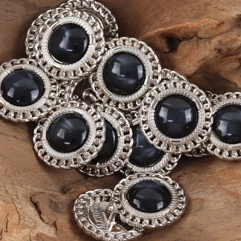 Silver-edged buttons with black resin gem centers and ornate scalloped metal rims