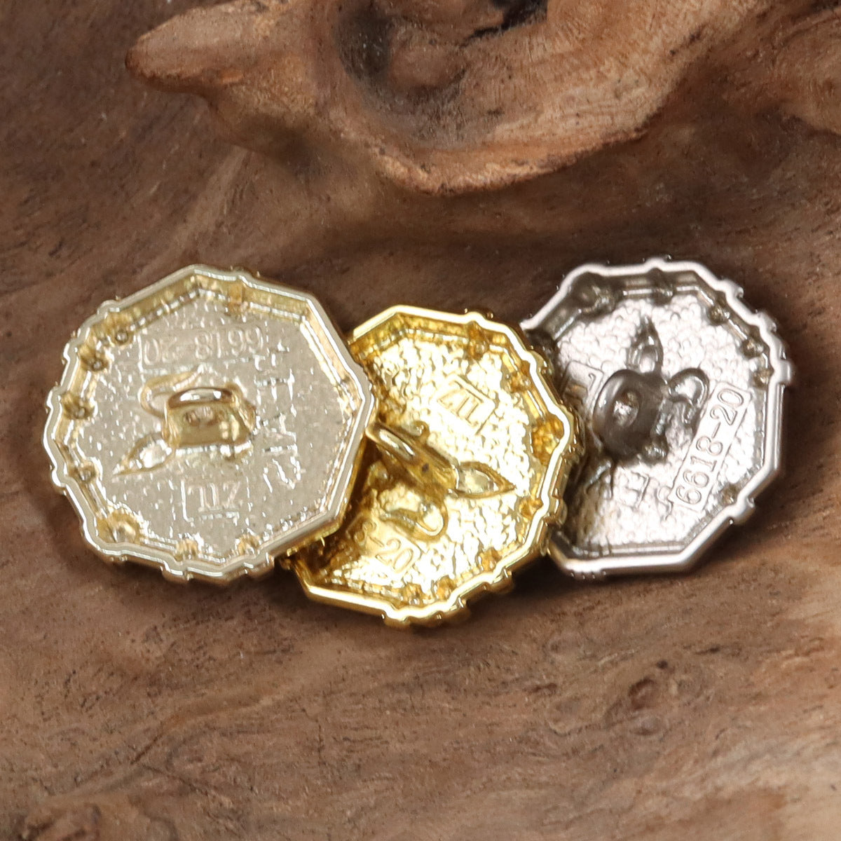 Metal buttons in gold and silver tones, each engraved with rabbit crest and “PEAS”