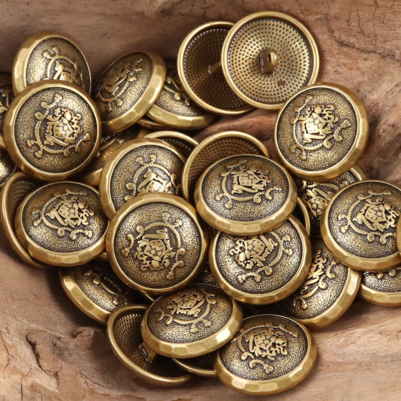 Gold-tone metal shank buttons with dark center panels, ornate crest embossing