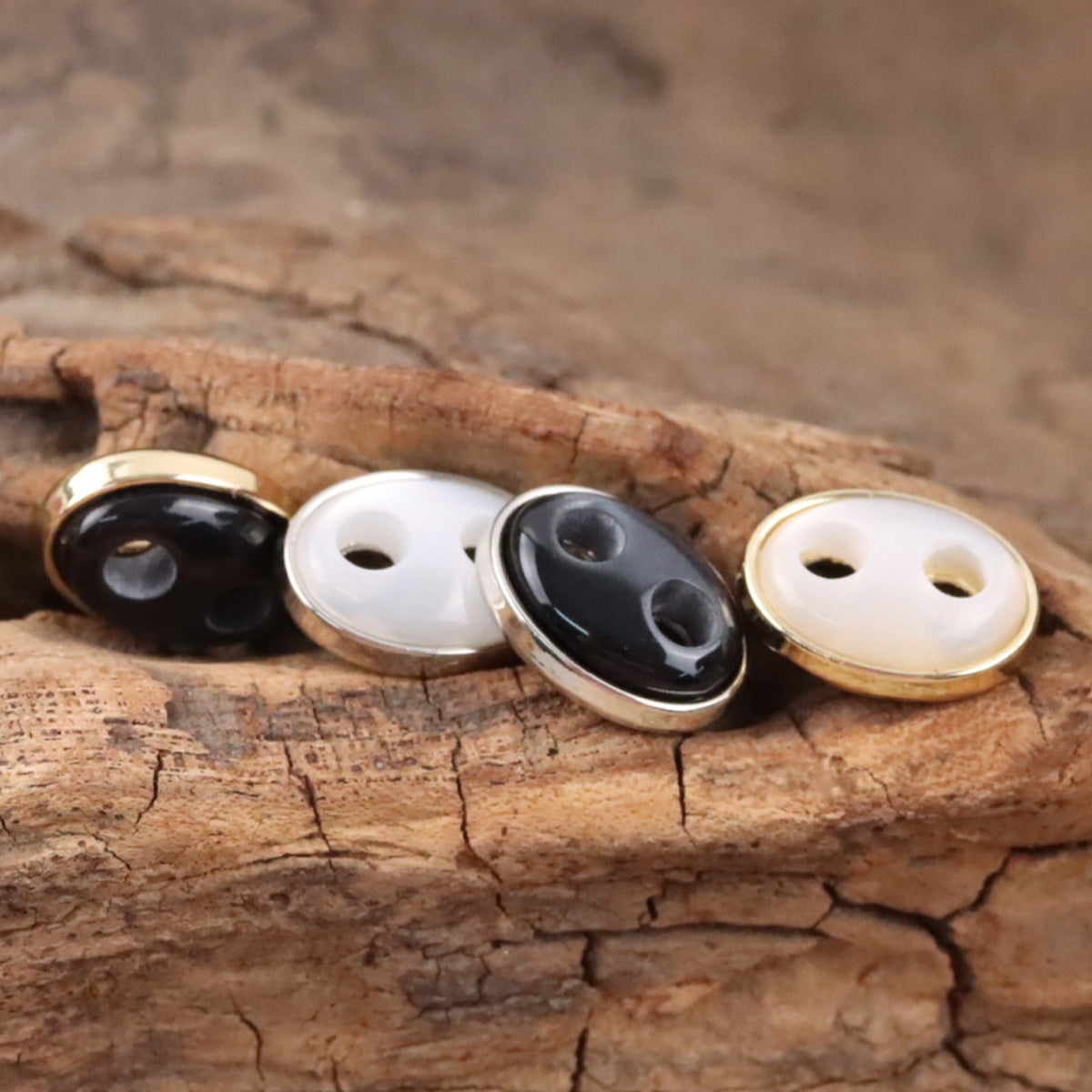 Pig nose resin buttons: black and white faces with gold-tone and dark-tone metal rims