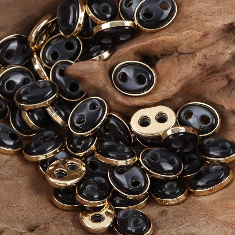 Pig nose resin buttons: black faces with gold-tone and silver-tone metal rims, oval 2-hole