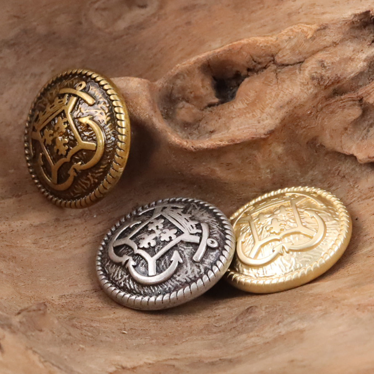 Anchor hook metal buttons in bronze and silver tones with crest emblem and knurled rim