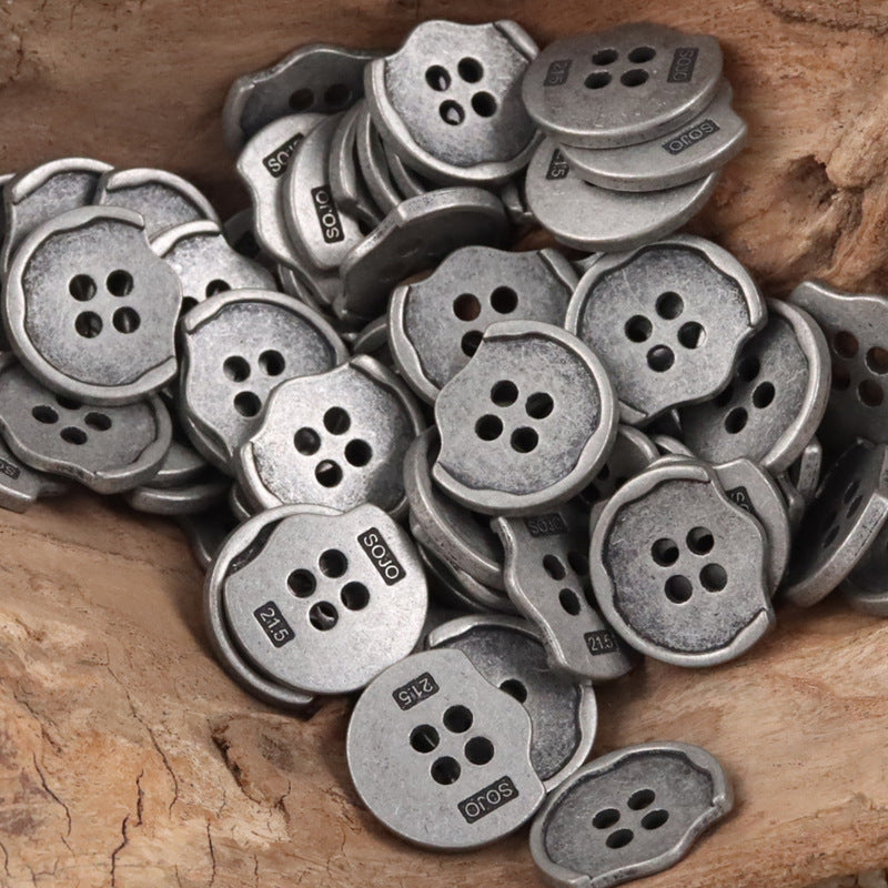 Matte silver irregular metal buttons, compact pile, each with 4-hole face