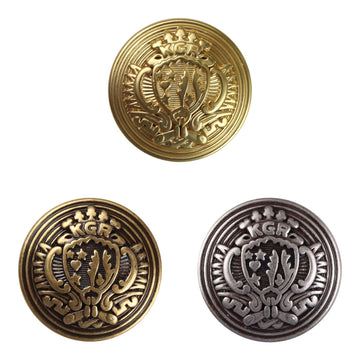 Gold-tone round metal shield button with ornate crest design and engraved border