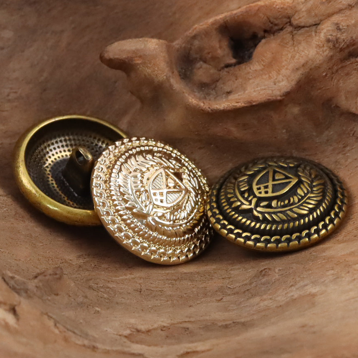 Bronze metal shank buttons, crest emblem with laurel border