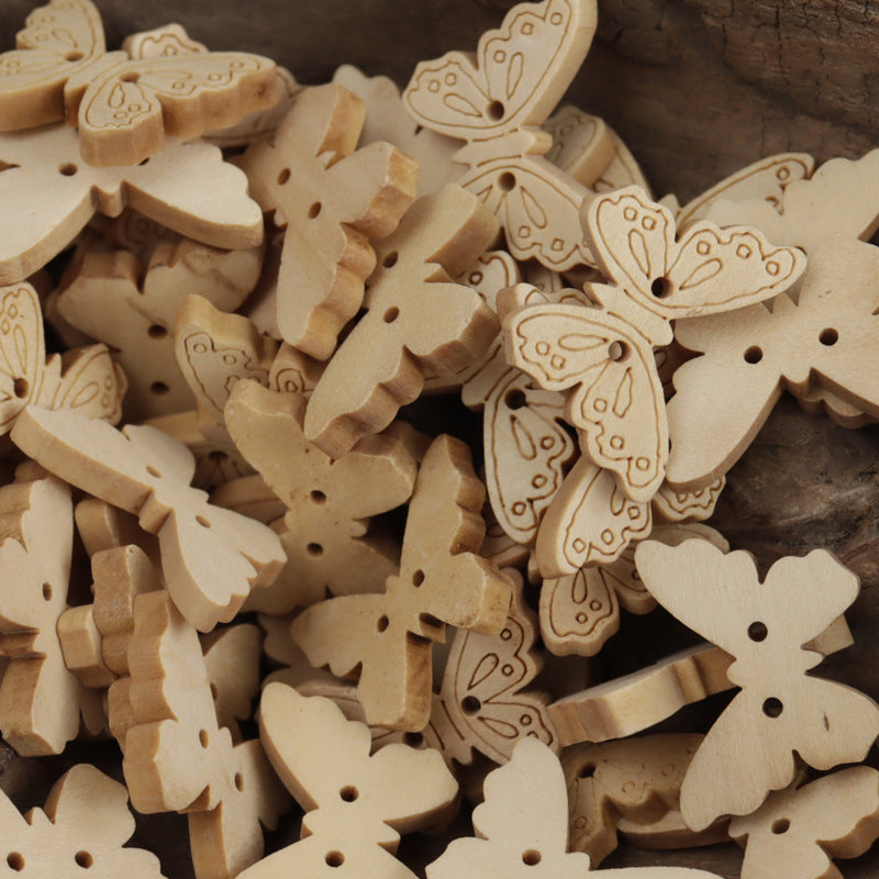 Assorted two-hole wooden buttons, including bear and butterfly shapes in natural log color