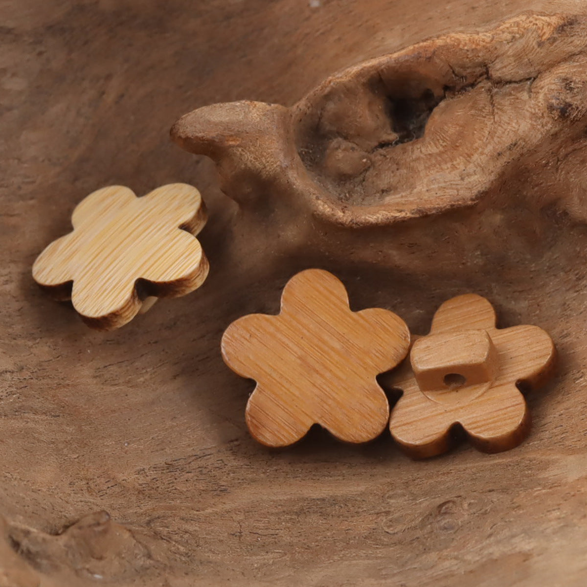 Light bamboo plum blossom buttons with holes, showing smooth carved edges
