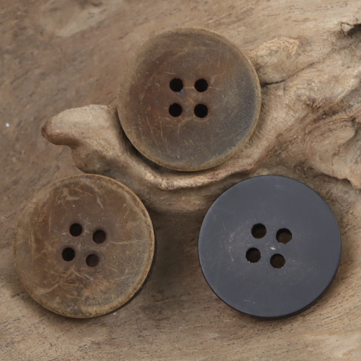 Mixed horn buttons: tan and dark slate, round flat, each with 4 holes