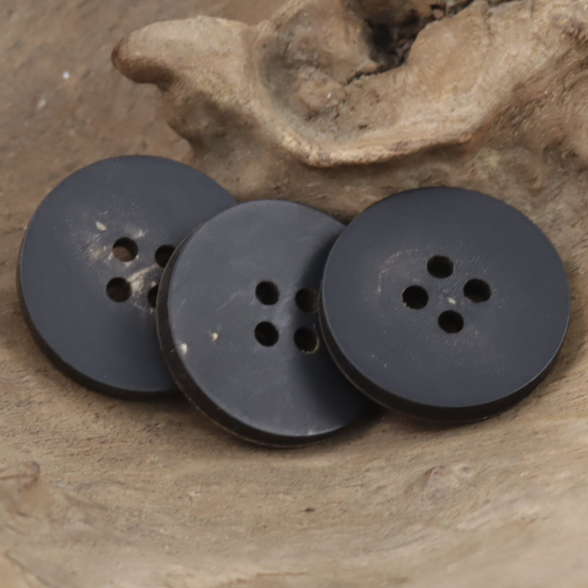 Dark slate horn buttons, round, flat, 4 holes (set view)