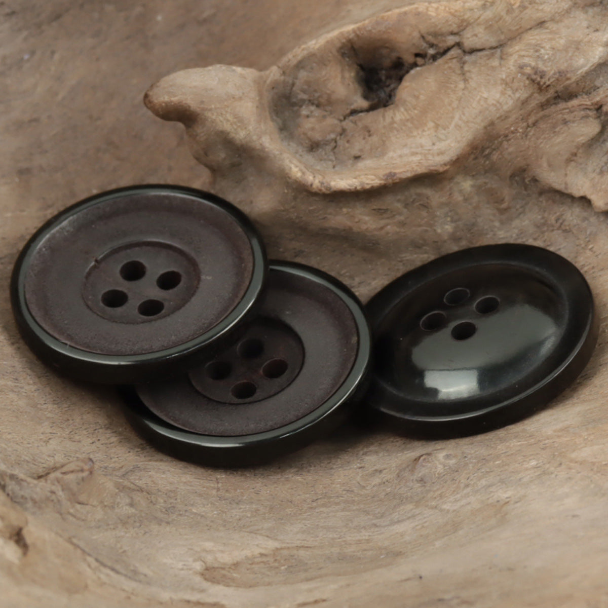 Set of 25mm round dark horn buttons with four holes