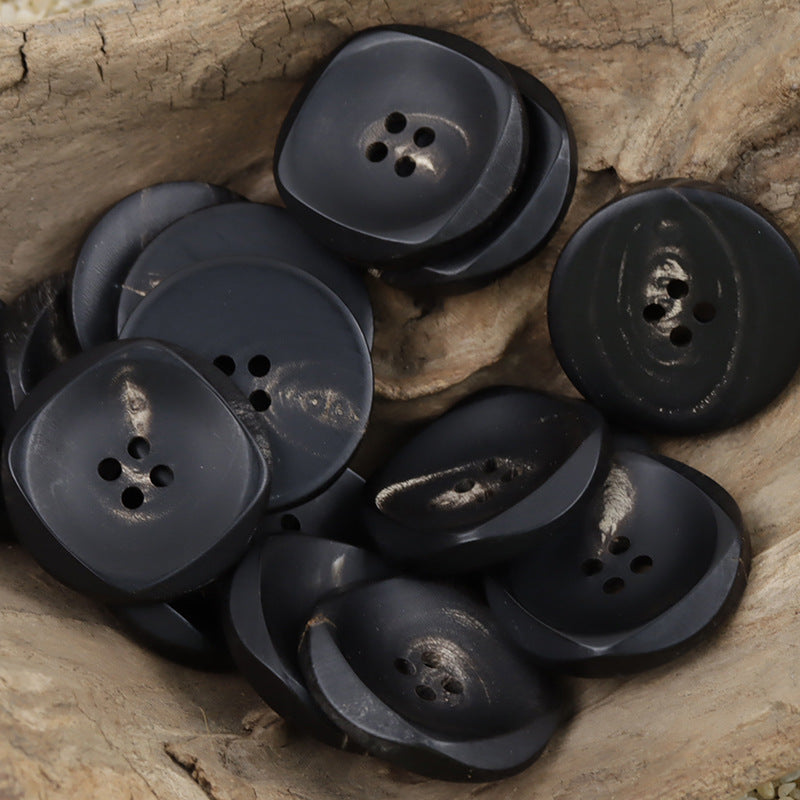 Assorted large black irregular horn buttons with 4-hole design, 5 shown