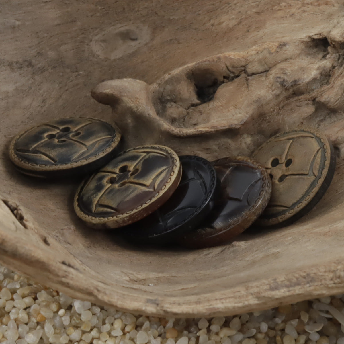 Laser-burnt horn-look buttons, round dark and bronze tones with cross-style 4-hole centers