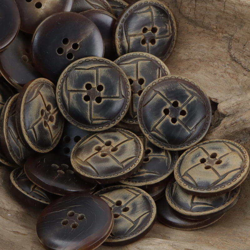 Round horn-look buttons pile, dark and bronze finishes with embossed ring edges and 4-hole faces