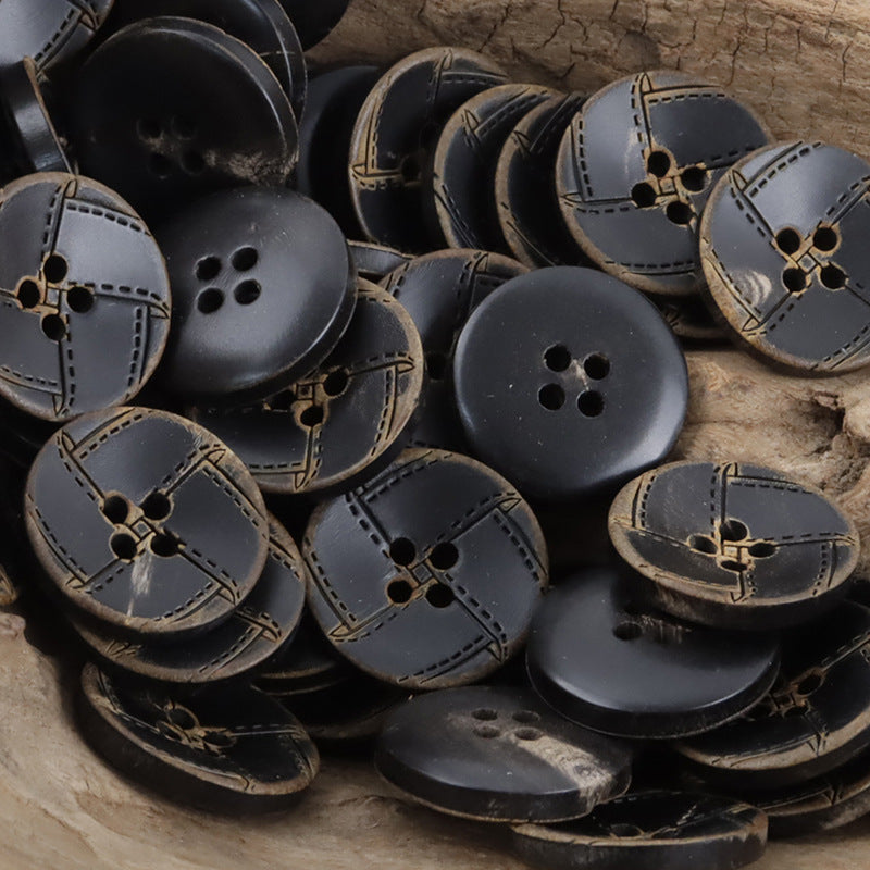 Assorted dark horn buttons, tan decorative stitching around 4-hole centers