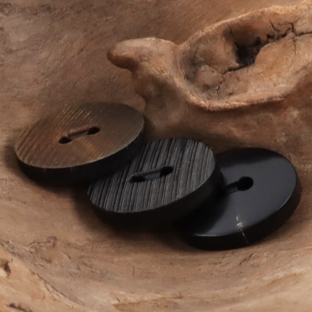 Horn button assortment in coffee and black tones, textured finish and button eyes
