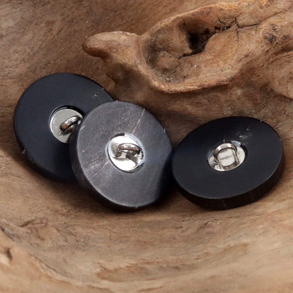 Black shank buttons with metal loop backs and smooth round front faces