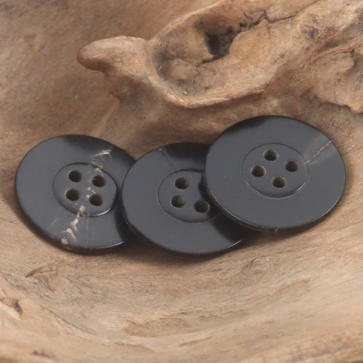 Dark ox horn buttons, 22mm, four-hole round design with subtle surface marks