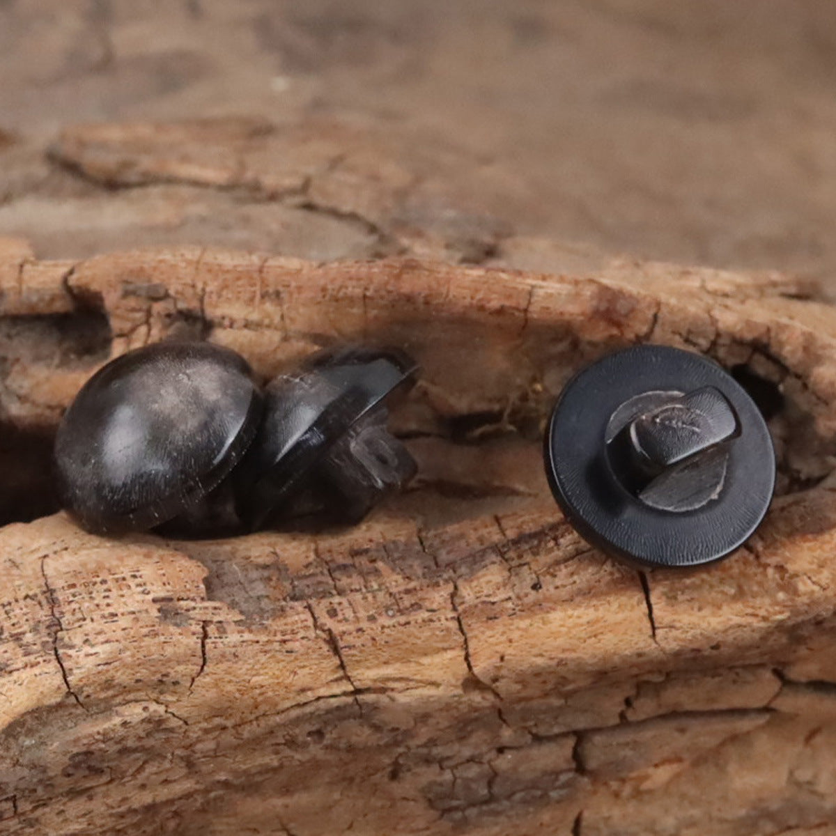 Black mushroom-head horn button with textured cap and loop back