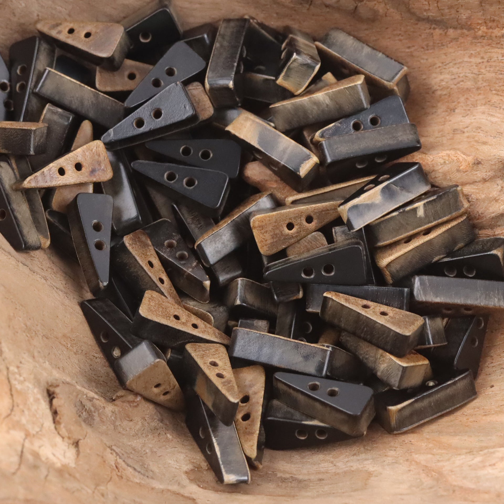 Triangular ox horn buttons, assorted dark and tan colors, small two-hole shapes